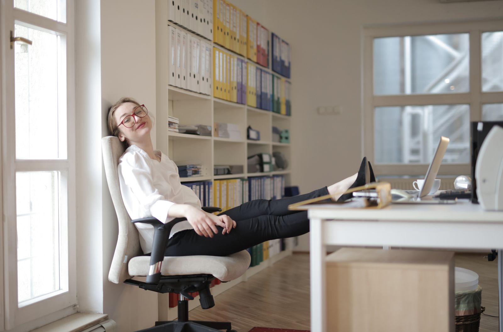 Feet relaxed near a footrest for standing desk setup in a home office