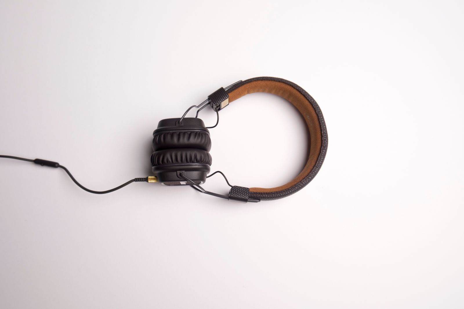 Black over-ear headphones on a desk illustrating Sony WH-1000XM5 warranty and buying channel